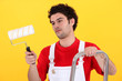 Man on step-ladder holding paint roller