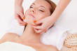 Photo: woman receiving chin massage woman receiving chin massage