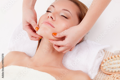Photo: woman receiving chin massage woman receiving chin massage