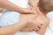Mother hand massaging back muscle  of her baby,touch of Happines
