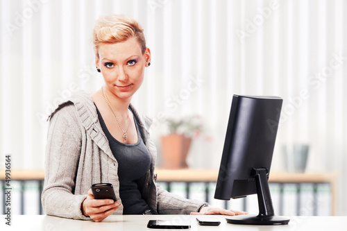 Photo: with smartphone in the office with smartphone in the office