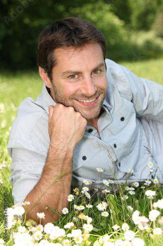 Photo: Man lying in the daisies Man lying in the daisies