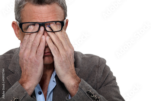 Photo: Man rubbing his eyes Man rubbing his eyes