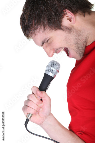 Photo: Man singing into microphone Man singing into microphone