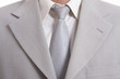 Photo: detail of a Business man Suit with silver tie detail of a Business man Suit with silver tie