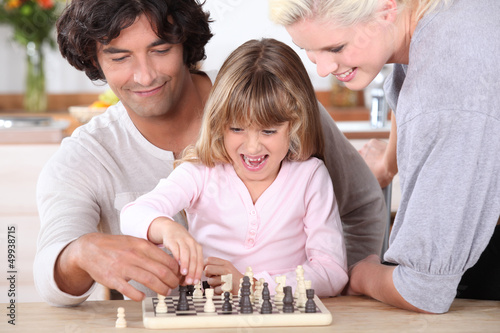 Photo: Father and daughter playing chess Father and daughter playing chess