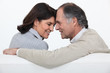 Married couple sat face to face on sofa
