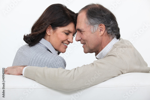 Photo: Married couple sat face to face on sofa Married couple sat face to face on sofa