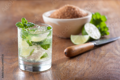 Photo: Mojito served in a glass with crushed ice and lime Mojito served in a glass with crushed ice and lime