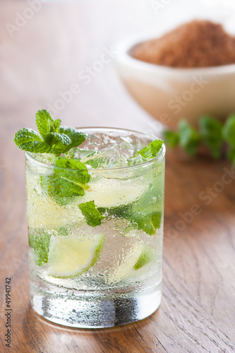 Photo: Mojito served in a glass with crushed ice and lime Mojito served in a glass with crushed ice and lime
