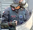police in riot gear with shields and gas masks