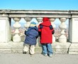 two Children who watch from the railing