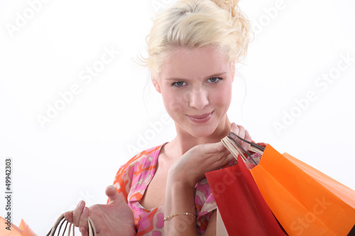 Photo: Blond woman carrying shopping bags Blond woman carrying shopping bags