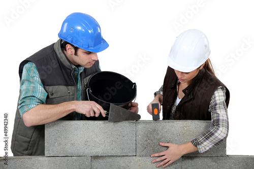 Photo: craftsman and craftswoman applying cement craftsman and craftswoman applying cement