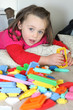 Little girl playing with building blocks