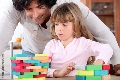 Photo: Little girl playing with building blocks Little girl playing with building blocks