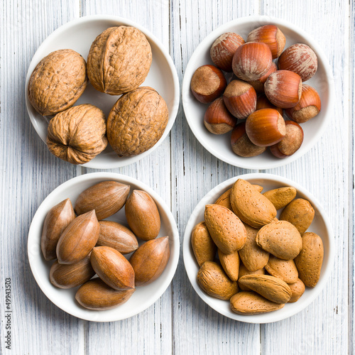Photo: various nuts in ceramic bowls various nuts in ceramic bowls