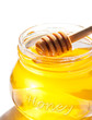 Honey dipper in jar isolated on white background