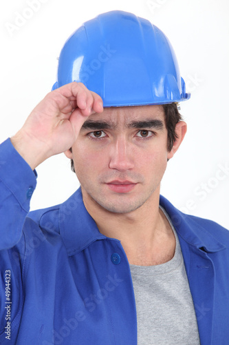Photo: A construction worker saluting. A construction worker saluting.
