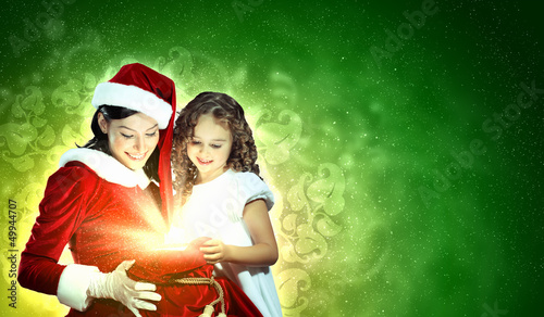 Photo: Little girl with christmas gifts and santa Little girl with christmas gifts and santa