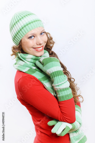 Photo: Young woman wearing winter hat and warm scarf Young woman wearing winter hat and warm scarf