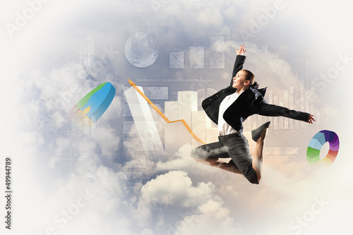 Photo: businesswoman in black suit jumping businesswoman in black suit jumping
