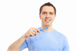 Young man at home brushing teeth