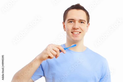 Photo: Young man at home brushing teeth Young man at home brushing teeth