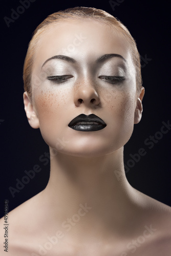 Photo: blonde girl with dark lipstick looks down blonde girl with dark lipstick looks down
