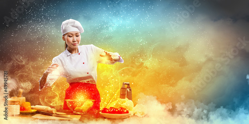 Photo: Asian female cooking with magic Asian female cooking with magic