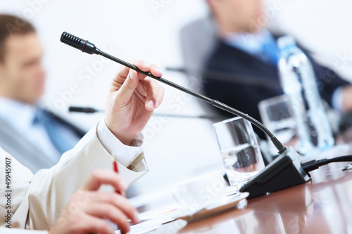 Photo: Hands of businessman holding microphone Hands of businessman holding microphone
