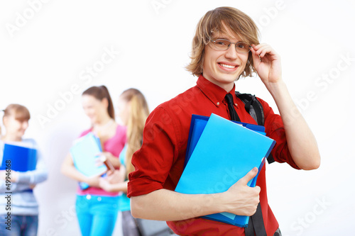 Photo: Student in red shirt with books Student in red shirt with books