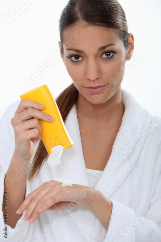 Photo: Woman putting on cream Woman putting on cream
