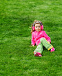 Preschool girl sitting on the hill