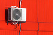 Photo: Airconditioning unit on a red wall Airconditioning unit on a red wall