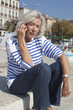 senior woman listening to a message on her mobile phone