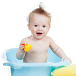 adorable baby taking bath in blue tub