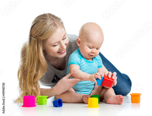 Photo: kid boy and mother playing together with cup toys kid boy and mother playing together with cup toys