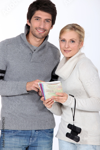 Photo: Couple with a map book Couple with a map book