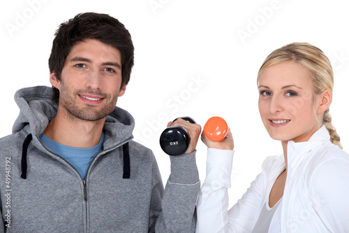 Photo: Young couple with dumbbells Young couple with dumbbells