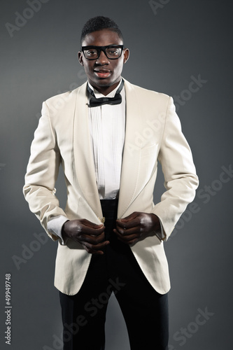 Photo: Stylish black american man in suit with glasses. Fashion studio Stylish black american man in suit with glasses. Fashion studio