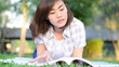 Beautiful young asian student is reading