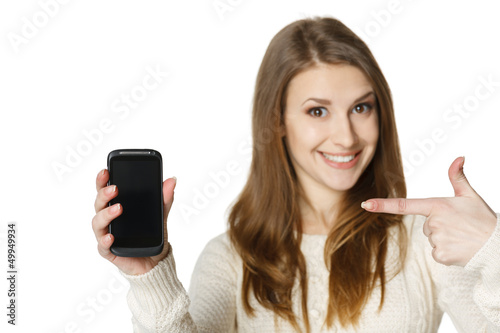 Photo: Closeup of happy young woman pointing at mobile phone Closeup of happy young woman pointing at mobile phone
