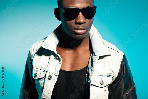 Photo: Cool urban stylish black american man. Fashion studio shot. Cool urban stylish black american man. Fashion studio shot.