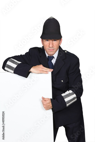 Photo: Policeman with blank advertising board Policeman with blank advertising board