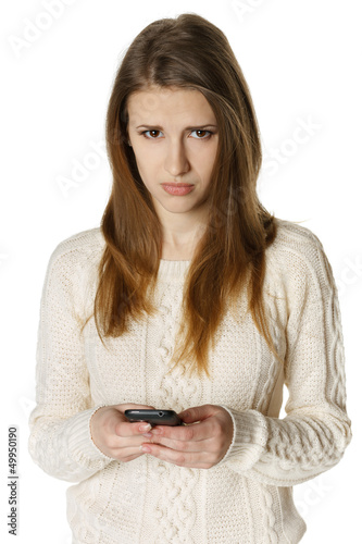 Photo: Woman is feeling sad while reading sms on mobile phone Woman is feeling sad while reading sms on mobile phone