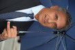 Businessman holding an umbrella