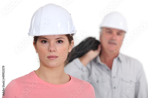 Photo: Builder with young female student Builder with young female student
