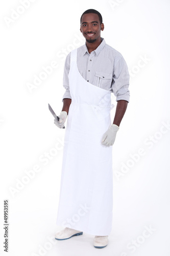 Photo: Full length studio portrait of a butcher with apron and knife Full length studio portrait of a butcher with apron and knife