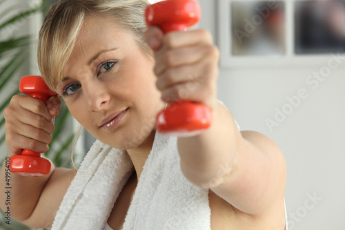 Photo: Young woman working out with dumbbells Young woman working out with dumbbells